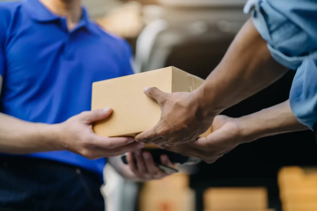 delivery person handing package to customer close utc ()